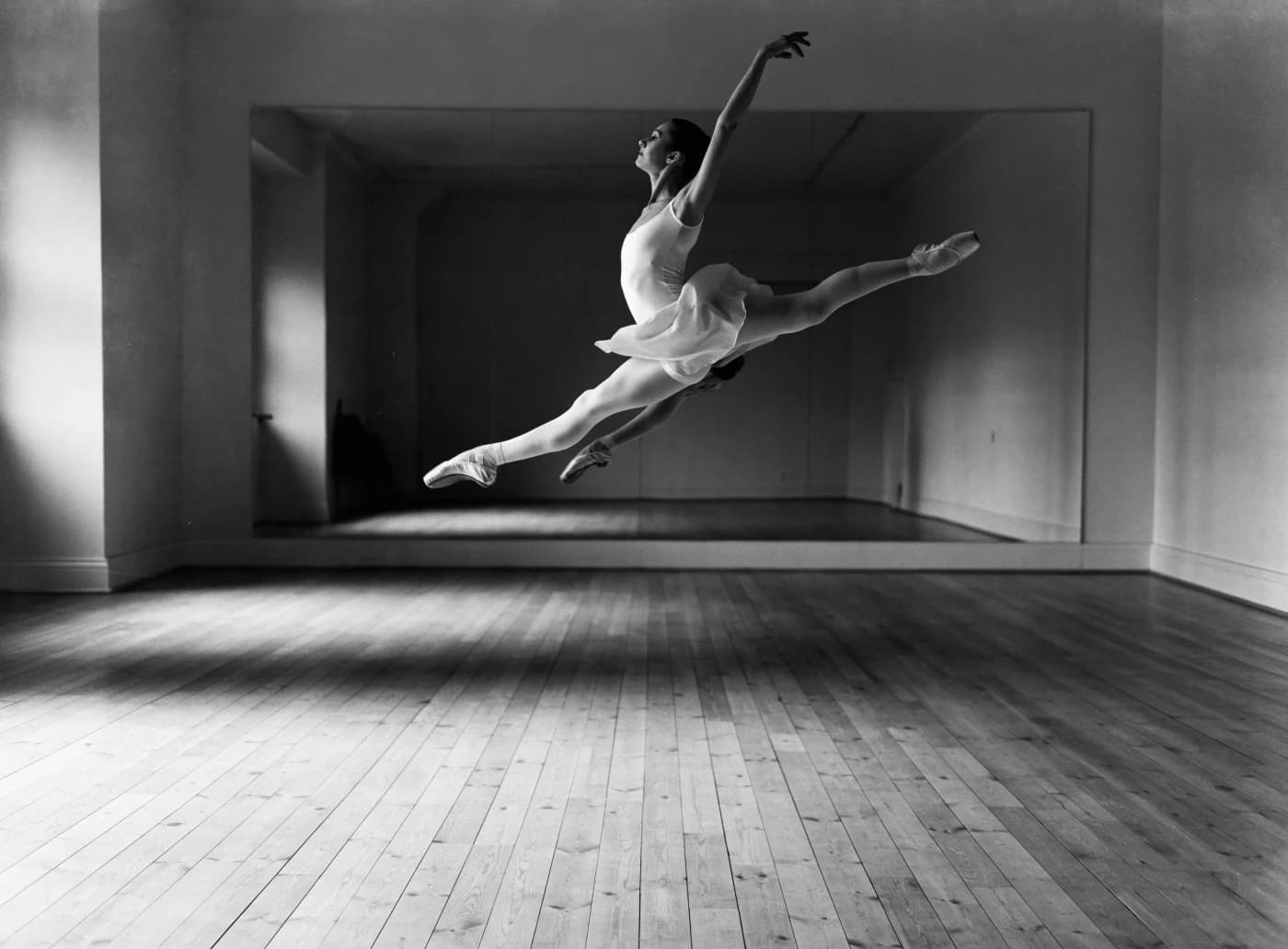 Mara Ilyina mid-leap in an empty rehearsal studio