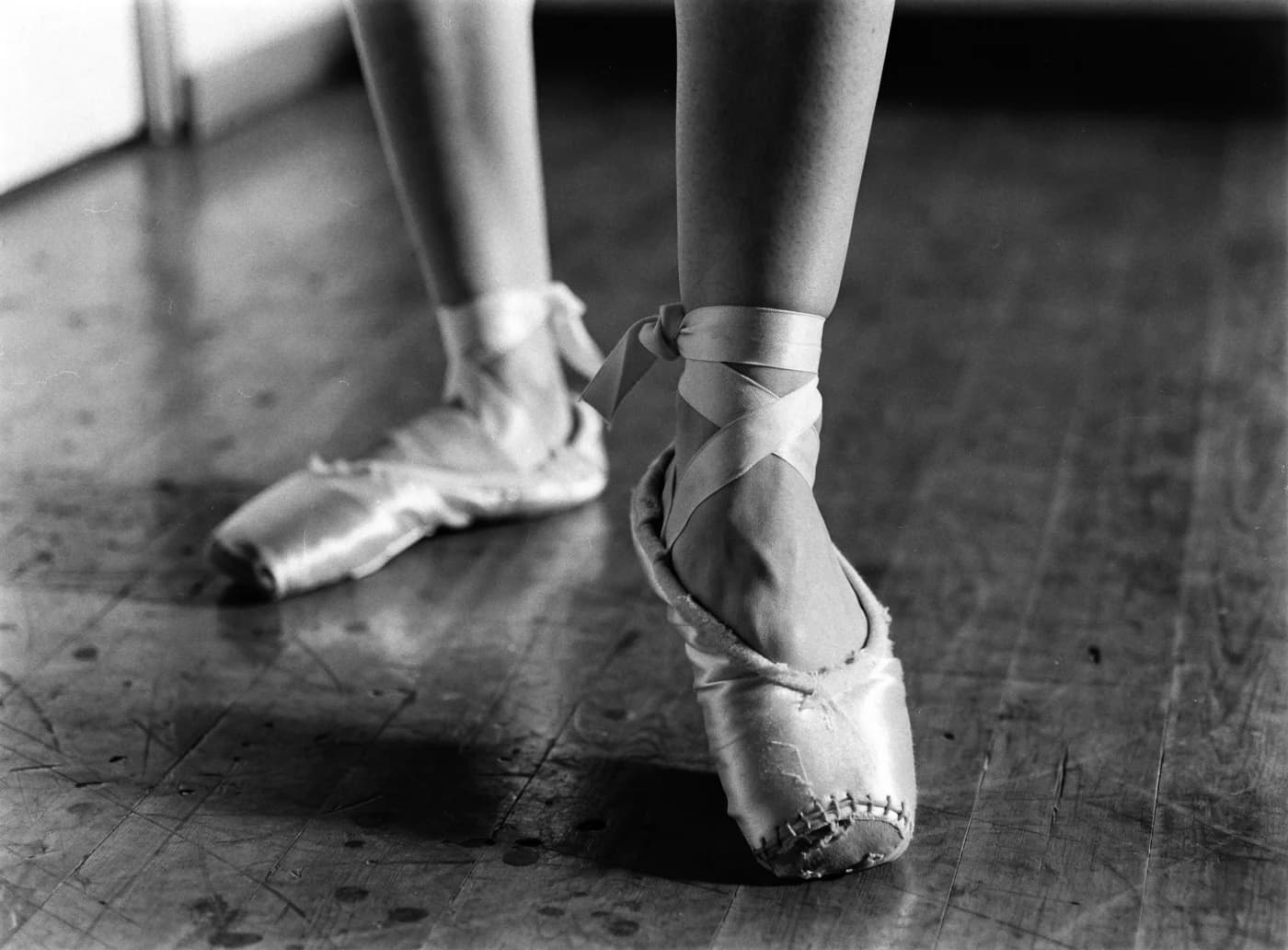Worn pointe shoes on a rehearsal studio floor
